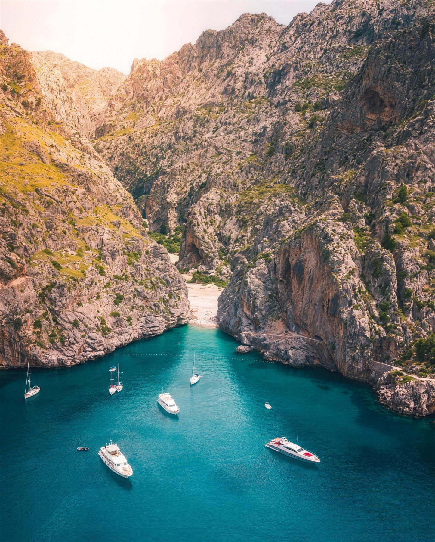 A turquoise cove between rugged mountains on the Mallorcan coast, Spain