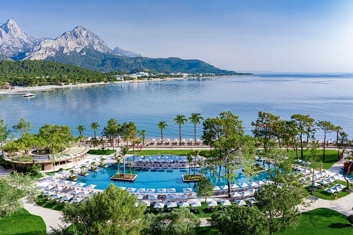 NG Phaselis Bay — infinity pool aerial with beach and mountains