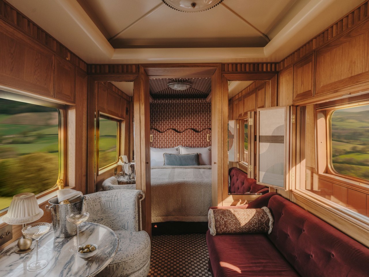 A Belmond suite with a sitting area and a bedroom beyond